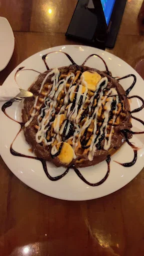 Waffle dessert with banana and chocolate sauce