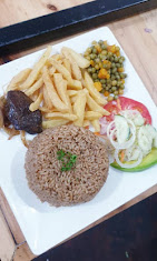 Hearty lunch plate with rice, fries and fresh salad